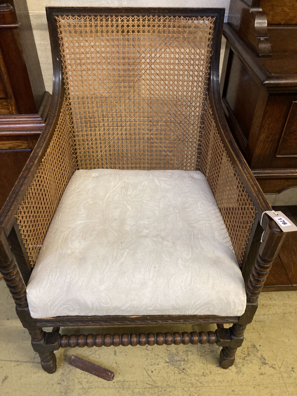A 1920s oak bergere armchair